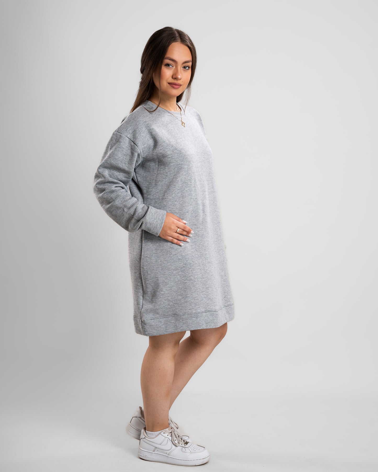 side look of Model wearing a grey Crew Neck Short Dress with long sleeves, casual style.