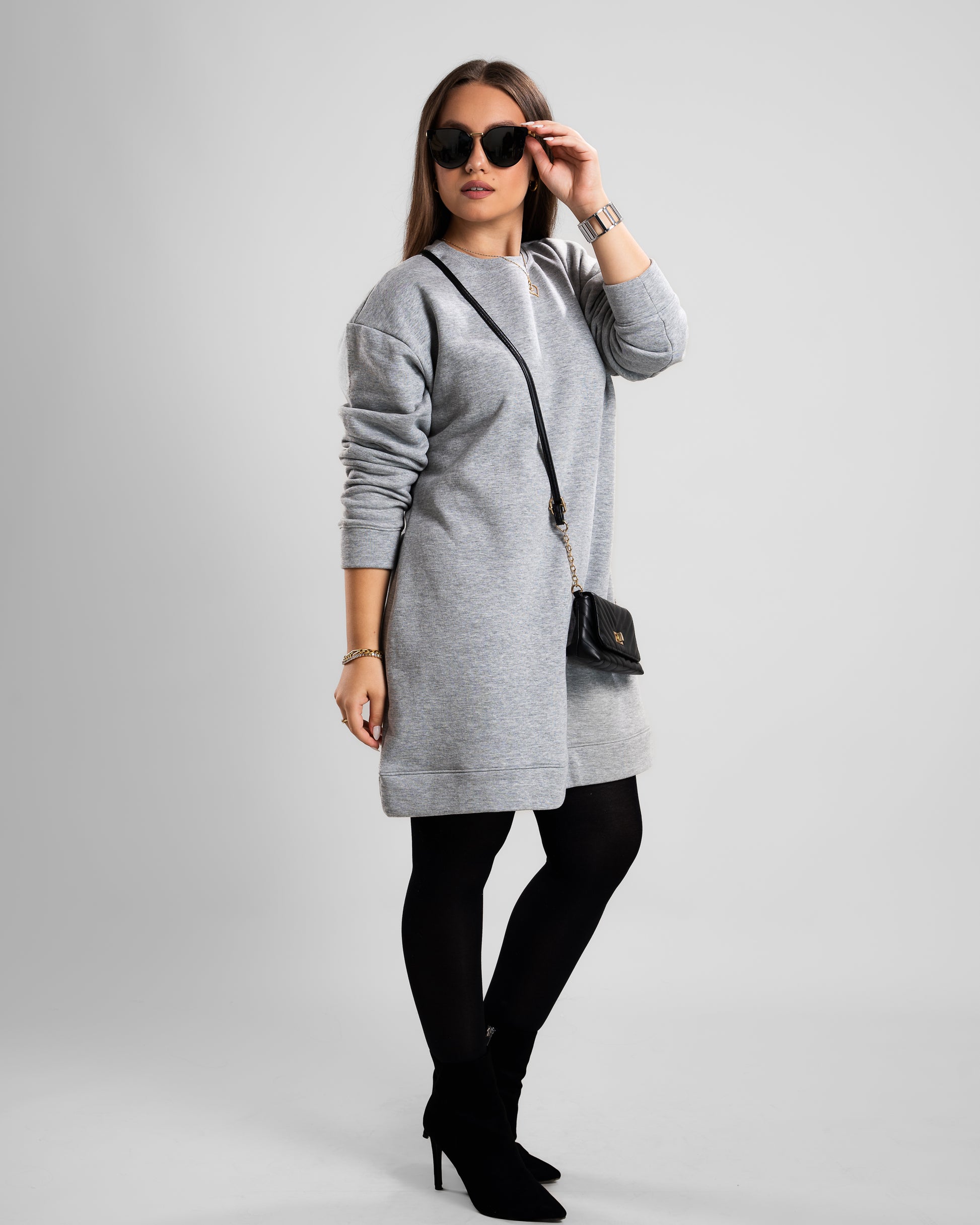 Grey short dress styled with winter boots for a chic cold-weather outfit.