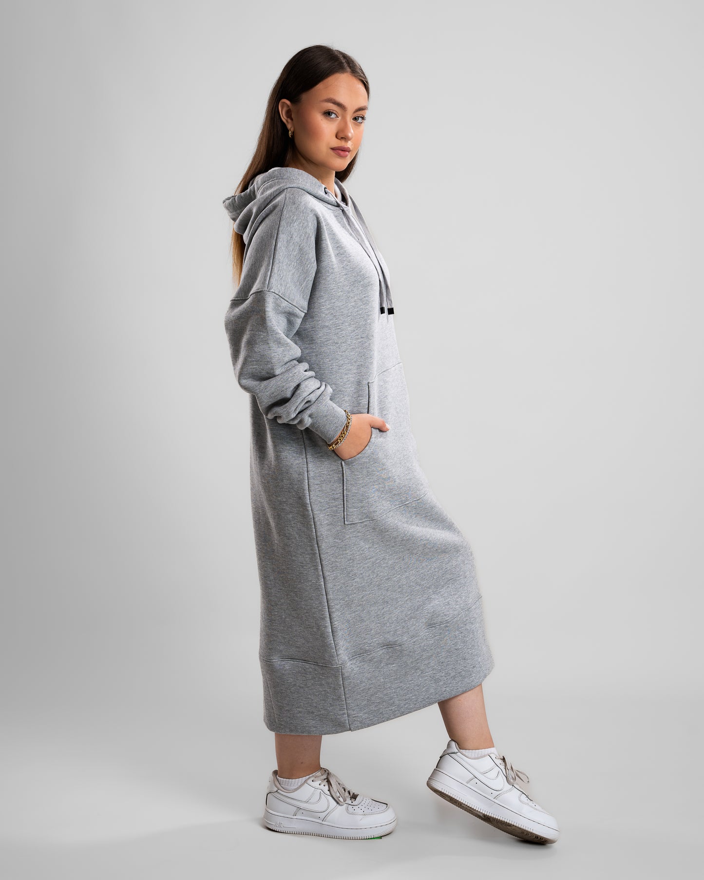 side view of Model in a grey Hoodie Long Dress with thick Melton fabric, cozy and stylish.